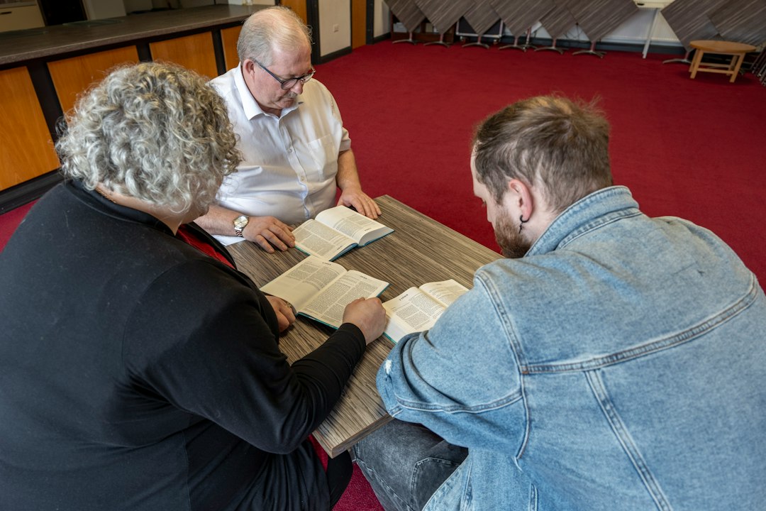 Editorial team reviewing manuscripts around a table